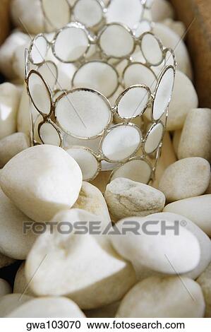 Close-up of decorative glasses on pebbles View Large Photo Image Stock Image - Close-up of decorative glasses on pebbles. Fotosearch