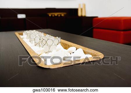 Stock Photograph - Close-up of decorative glasses on pebbles. Fotosearch