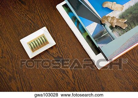Stock Photo - Close-up of magazines and an ashtray on a table. Fotosearch