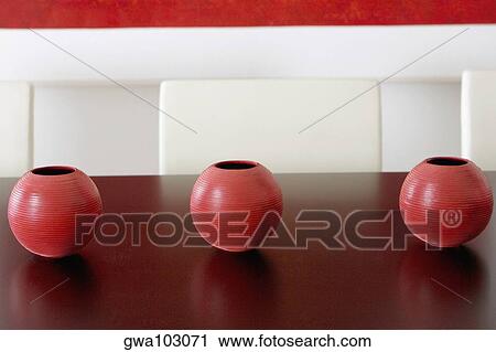 Close-up of three ceramic pots on a table View Large Photo Image Stock Image - Close-up of three ceramic pots on a table. Fotosearch