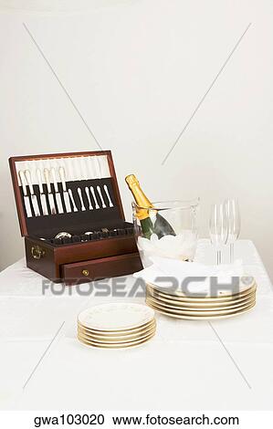 Cutlery box with a champagne bottle and tableware on a dining table View Large Photo Image Stock Image - Cutlery box with a champagne bottle and tableware on a dining table. Fotosearch