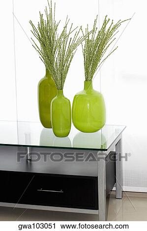 Dried leaves in vases on a table View Large Photo Image Stock Image - Dried leaves in vases on a table. Fotosearch