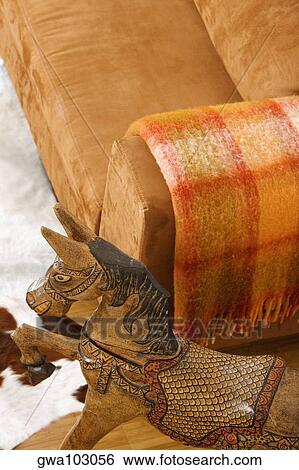 High angle view of a wooden horse near a couch View Large Photo Image Stock Photograph - High angle view of a wooden horse near a couch. Fotosearch