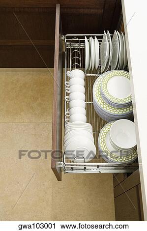 High angle view of potteries in a kitchen cabinet View Large Photo Image Stock Image - High angle view of potteries in a kitchen cabinet. Fotosearch