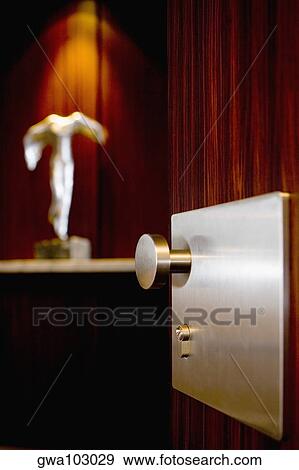 Metal doorknob on a wooden door View Large Photo Image Stock Photo - Metal doorknob on a wooden door. Fotosearch