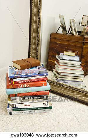 Stock Photo - Stack of books in front of a mirror. Fotosearch