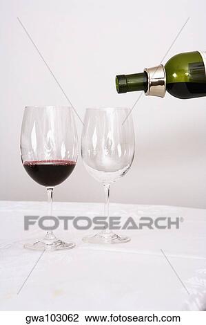 Wine being poured into wine glasses View Large Photo Image Stock Image - Wine being poured into wine glasses. Fotosearch