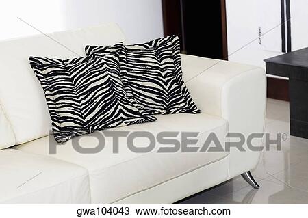 Stock Image - Close-up of two cushions on a couch. Fotosearch