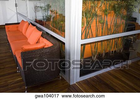 Stock Photo - Couch in a patio of a house. Fotosearch