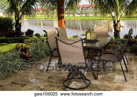 Stock Photography - Empty chair and tables in a lawn. Fotosearch
