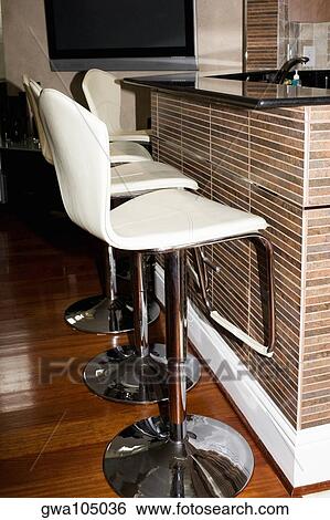 Stock Photograph - Row of chairs at a domestic kitchen. Fotosearch