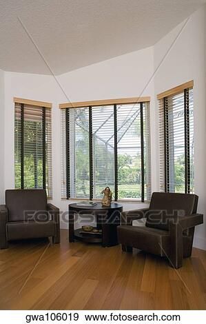 Stock Photo - Armchairs and a table in a bedroom. Fotosearch