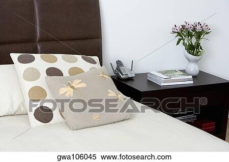 Bed and a side table in a bedroom View Large Photo Image Stock Photography - Bed and a side table in a bedroom. Fotosearch