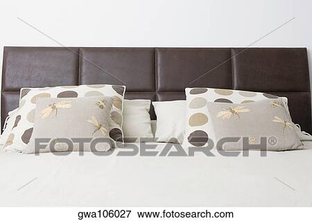 Stock Photo - Cushions and pillows on the bed. Fotosearch