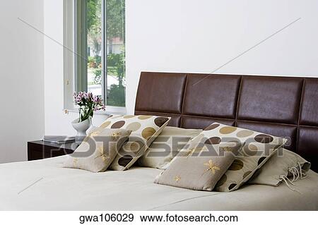 Stock Photo - Cushions and pillows on the bed. Fotosearch