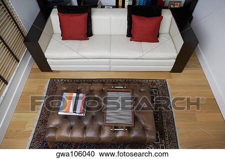 Stock Image - High angle view of a serving tray and towels on a table in a living room. Fotosearch
