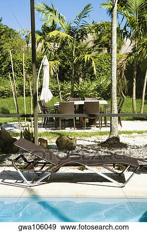 Lounge chair at the poolside View Large Photo Image Stock Photo - Lounge chair at the poolside. Fotosearch