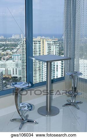 Table with chairs in a hotel View Large Photo Image Picture - Table with chairs in a hotel. Fotosearch