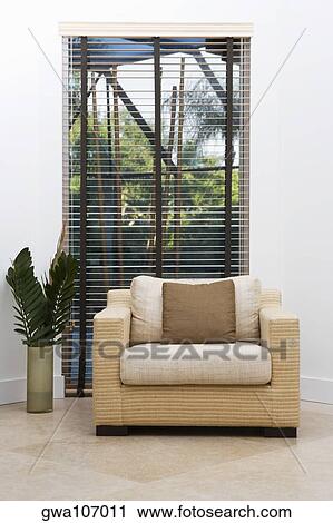 Stock Image - Armchair in front of a window. Fotosearch
