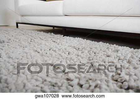 Stock Photo - Carpet and a couch in a living room. Fotosearch
