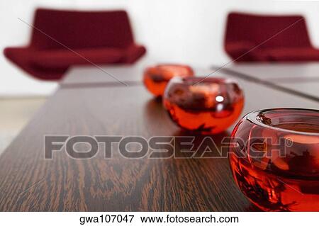 Close-up of candlestick holders in a row on a table View Large Photo Image Stock Photo - Close-up of candlestick holders in a row on a table. Fotosearch