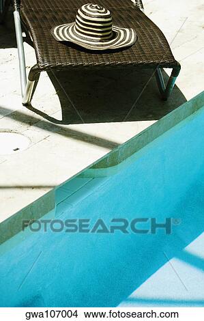 High angle view of a lounge chair at the poolside View Large Photo Image Picture - High angle view of a lounge chair at the poolside. Fotosearch