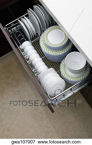 High angle view of potteries in a kitchen cabinet View Large Photo Image Stock Photo - High angle view of potteries in a kitchen cabinet. Fotosearch