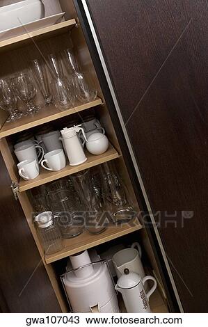 Potteries in a kitchen cabinet View Large Photo Image Stock Image - Potteries in a kitchen cabinet. Fotosearch