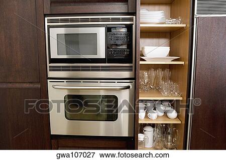 Potteries in a kitchen cabinet View Large Photo Image Stock Photo - Potteries in a kitchen cabinet. Fotosearch