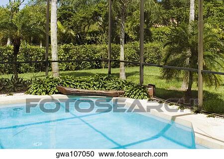 Stock Image - Swimming pool in a garden. Fotosearch