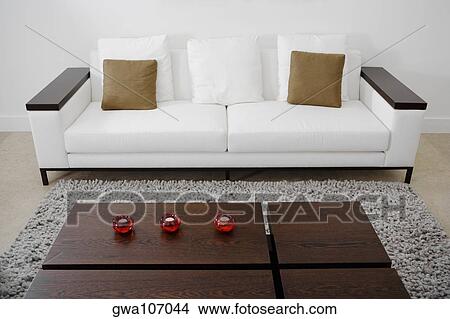 Picture - Table and a couch in a living room. Fotosearch