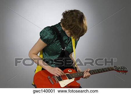 Close-up of a female guitarist playing a guitar View Large Photo Image Stock Image - Close-up of a female guitarist playing a guitar. Fotosearch