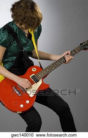 Close-up of a female guitarist playing a guitar View Large Photo Image Stock Image - Close-up of a female guitarist playing a guitar. Fotosearch