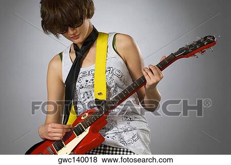 Close-up of a female guitarist playing a guitar View Large Photo Image Stock Photo - Close-up of a female guitarist playing a guitar. Fotosearch