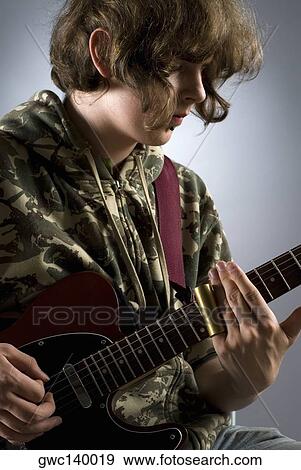Close-up of a female guitarist playing a guitar View Large Photo Image Stock Photo - Close-up of a female guitarist playing a guitar. Fotosearch