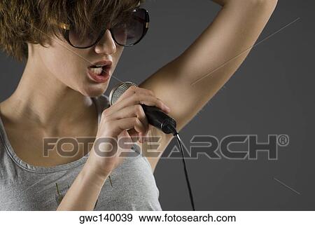 Close-up of a female singer singing View Large Photo Image Stock Photo - Close-up of a female singer singing. Fotosearch