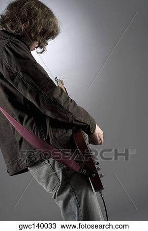 Close-up of a guitarist playing a guitar View Large Photo Image Stock Image - Close-up of a guitarist playing a guitar. Fotosearch