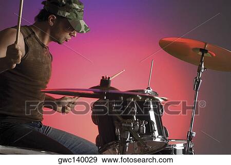 Close-up of a male drummer playing drums View Large Photo Image Stock Photo - Close-up of a male drummer playing drums. Fotosearch