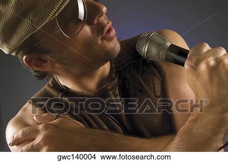Close-up of a male singer singing View Large Photo Image Picture - Close-up of a male singer singing. Fotosearch