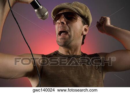 Close-up of a male singer singing View Large Photo Image Picture - Close-up of a male singer singing. Fotosearch