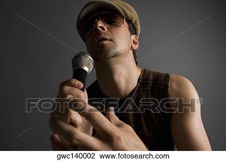 Close-up of a male singer singing View Large Photo Image Stock Image - Close-up of a male singer singing. Fotosearch