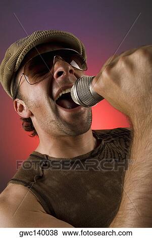 Close-up of a male singer singing View Large Photo Image Stock Photo - Close-up of a male singer singing. Fotosearch