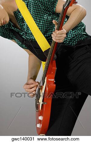 Female guitarist playing a guitar View Large Photo Image Stock Image - Female guitarist playing a guitar. Fotosearch