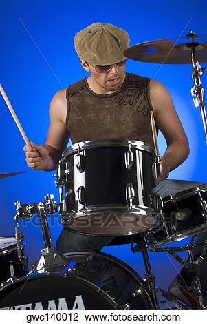 Stock Image - Male drummer playing drums. Fotosearch