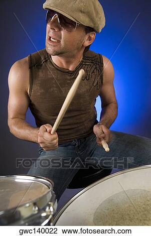 Stock Image - Male drummer playing drums. Fotosearch