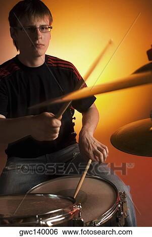 Stock Photograph - Male drummer playing drums. Fotosearch