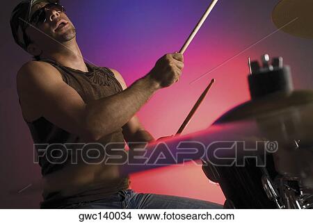 Side profile of a male drummer playing drums View Large Photo Image Picture - Side profile of a male drummer playing drums. Fotosearch