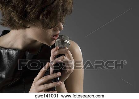 Close-up of a female singer singing View Large Photo Image Stock Image - Close-up of a female singer singing. Fotosearch