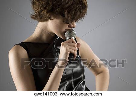 Close-up of a female singer singing View Large Photo Image Stock Image - Close-up of a female singer singing. Fotosearch