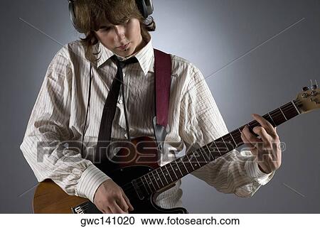 Close-up of a guitarist playing a guitar View Large Photo Image Stock Image - Close-up of a guitarist playing a guitar. Fotosearch